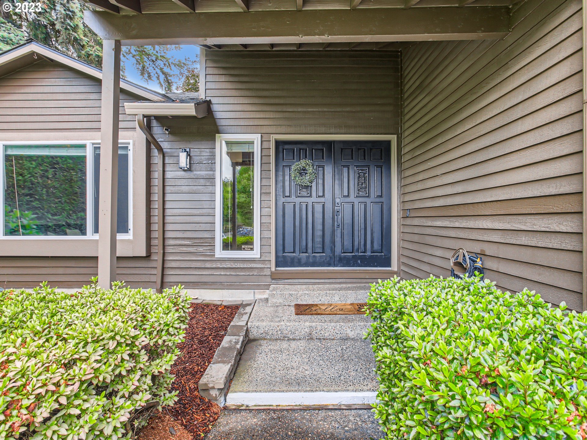 10230 Southwest Kickapoo Court Tualatin, OR 97062 - Photo 3 of 26 a front view of a house with garden