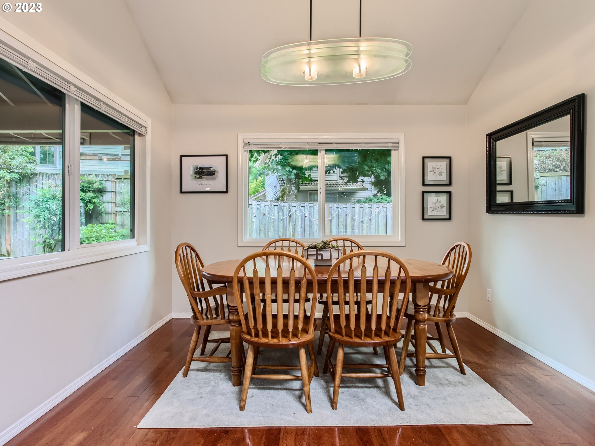 10230 Southwest Kickapoo Court Tualatin, OR 97062 - Photo 8 of 26 a view of a dining room with furniture window and wooden floor
