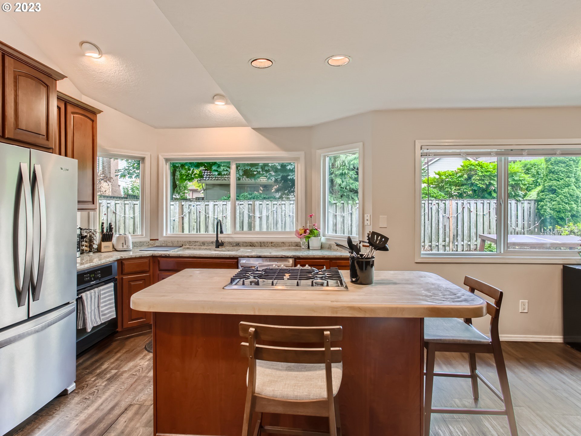 10230 Southwest Kickapoo Court Tualatin, OR 97062 - Photo 10 of 26 a kitchen with a sink stove and refrigerator