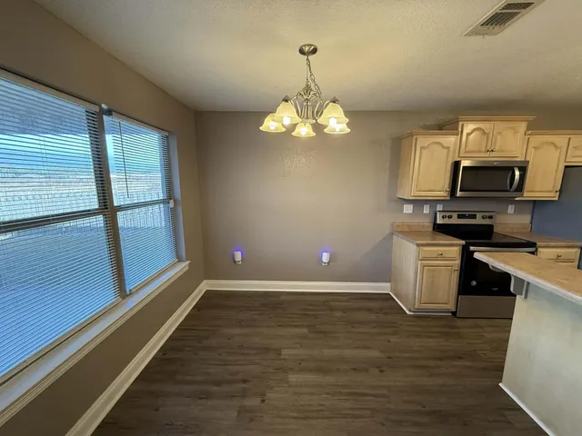 a view of a kitchen with stove and microwave