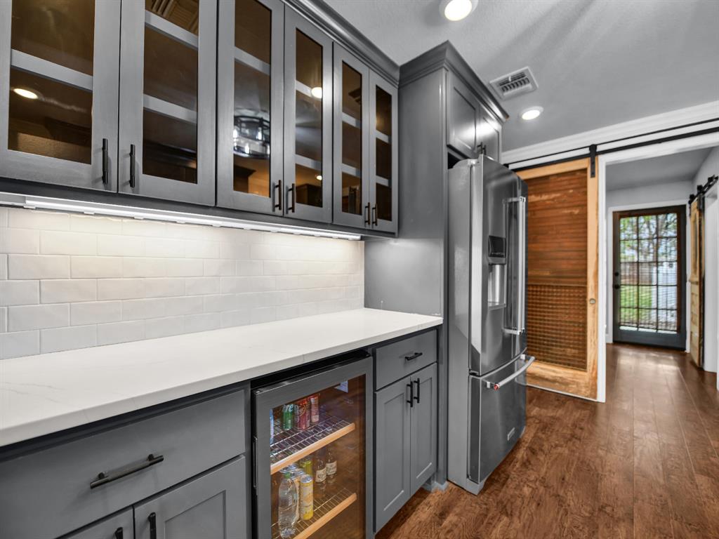 305 Gandy Street Lipan, TX 76462 - Photo 13 of 40 a kitchen with a sink and a refrigerator