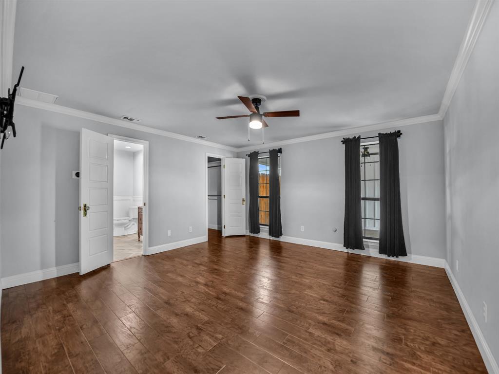305 Gandy Street Lipan, TX 76462 - Photo 18 of 40 a view of an empty room with window and wooden floor