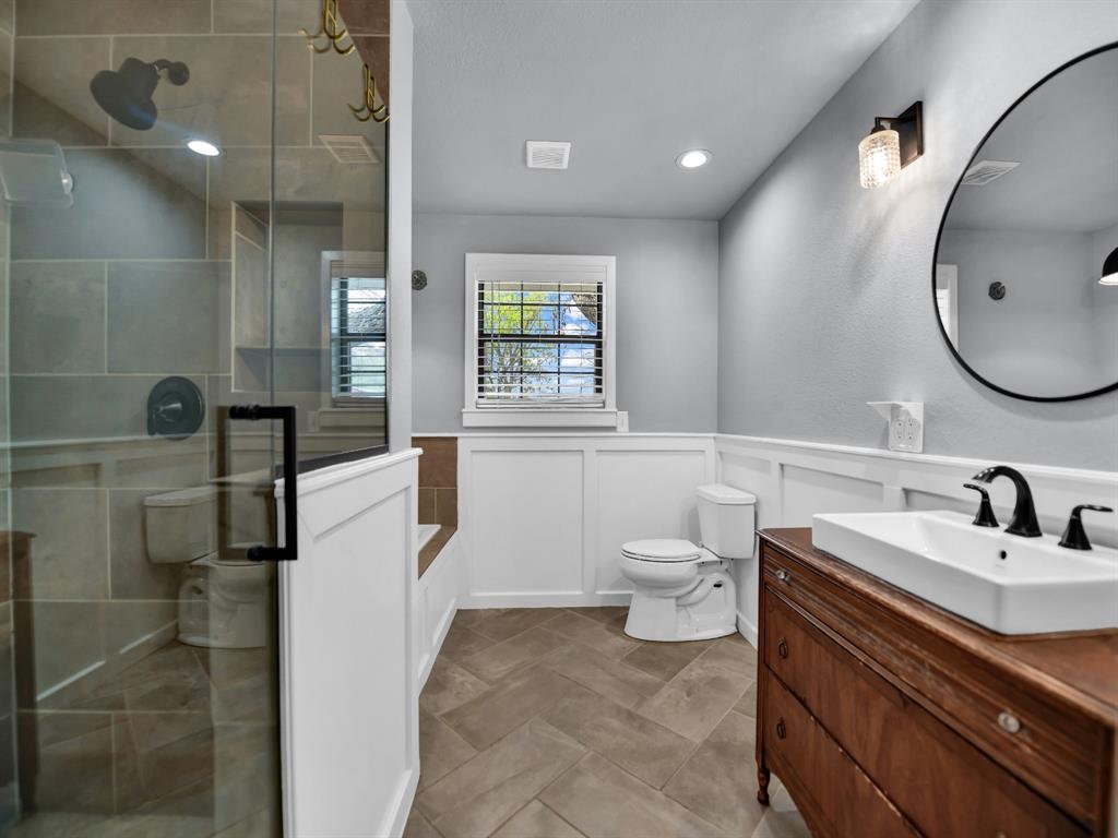 305 Gandy Street Lipan, TX 76462 - Photo 19 of 40 a bathroom with a sink a toilet and a mirror