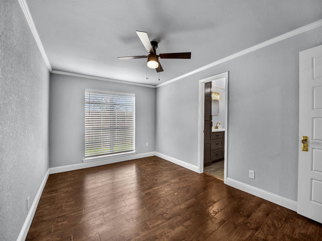 305 Gandy Street Lipan, TX 76462 - Photo 22 of 40 a view of an empty room with wooden floor and a window