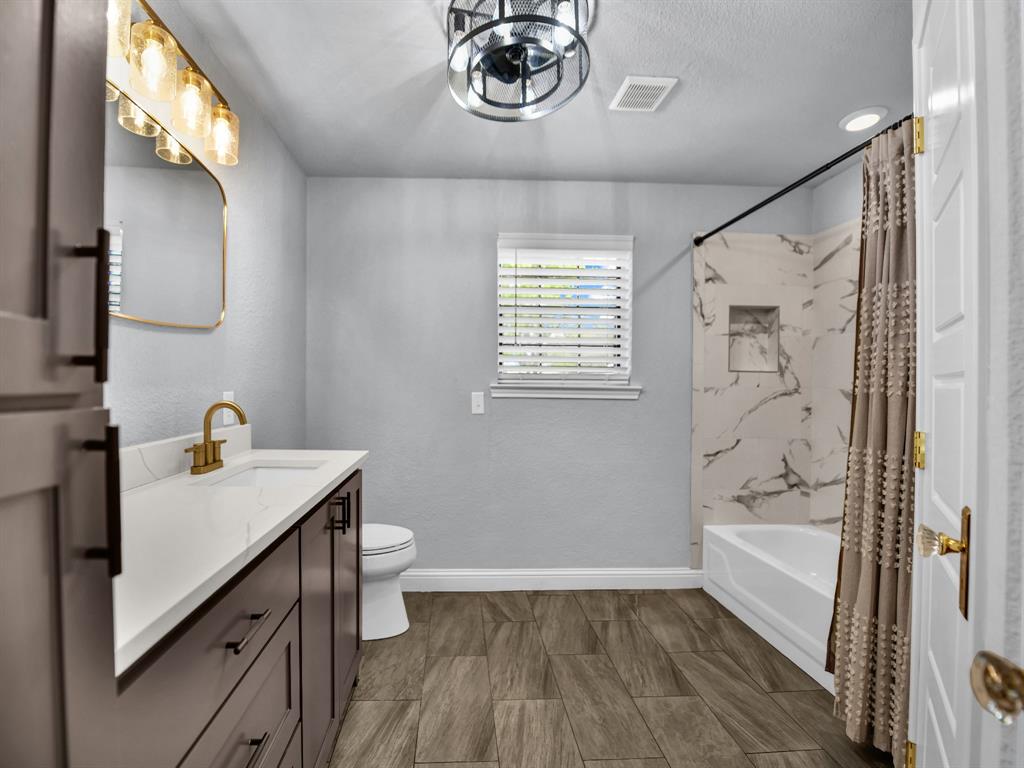 305 Gandy Street Lipan, TX 76462 - Photo 25 of 40 a bathroom with a sink a toilet and a bathtub