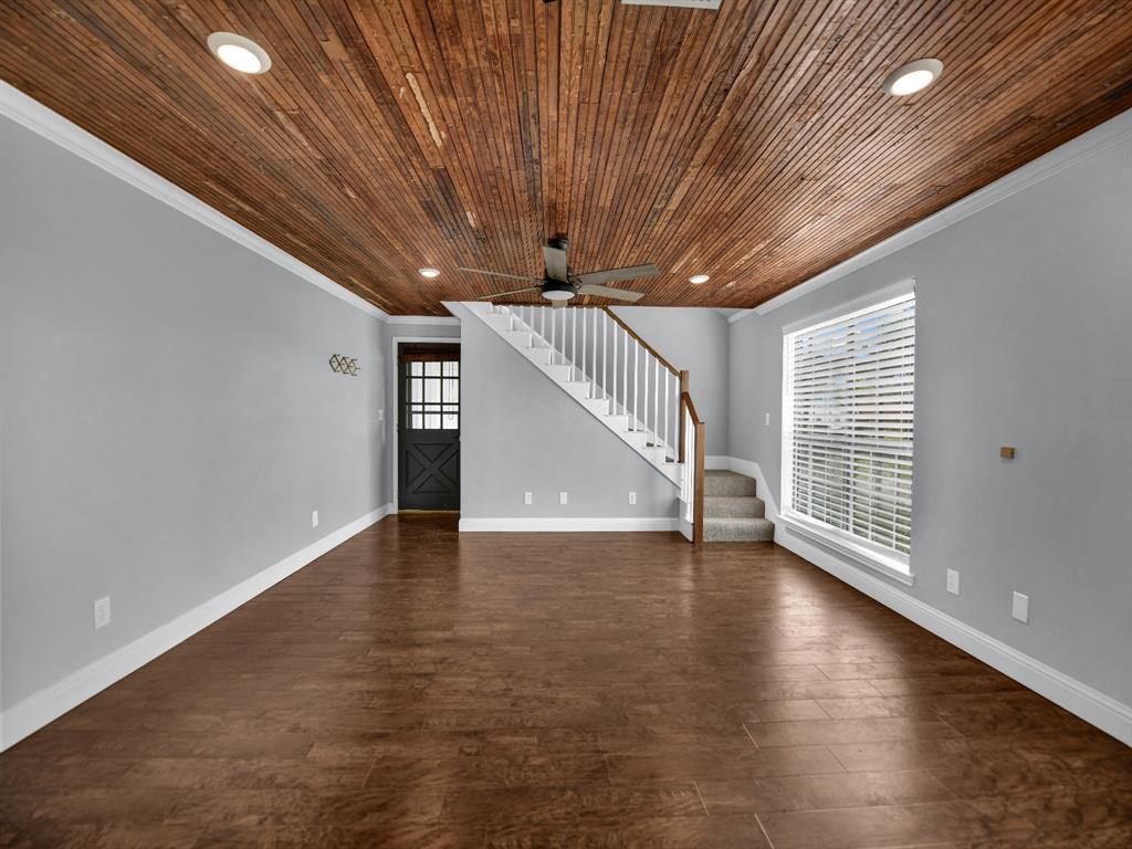 305 Gandy Street Lipan, TX 76462 - Photo 26 of 40 a view of an empty room with wooden floor and a window