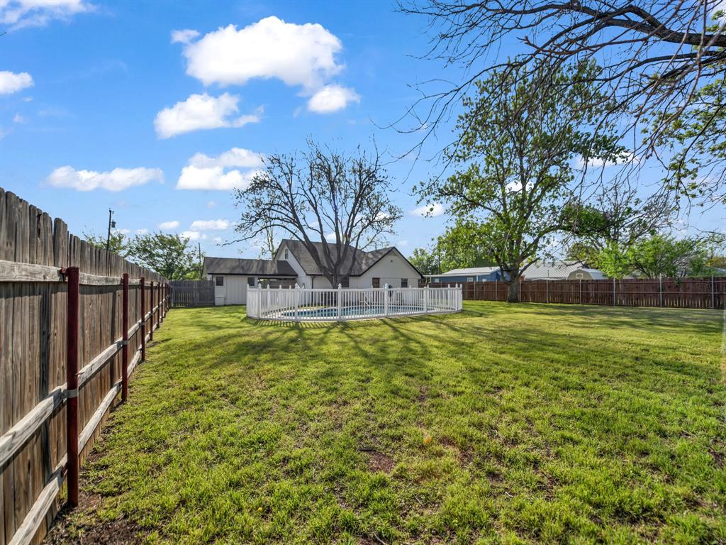 305 Gandy Street Lipan, TX 76462 - Photo 29 of 40 a view of a swimming pool with a garden