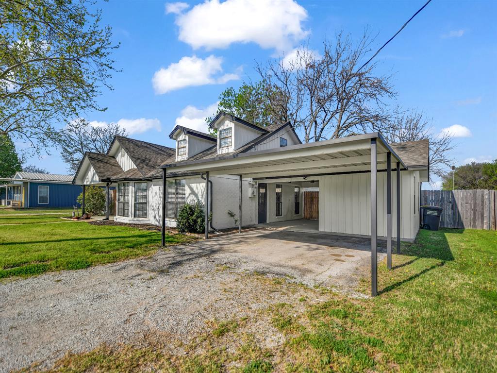 305 Gandy Street Lipan, TX 76462 - Photo 3 of 40 a view of a house with a yard and potted plants