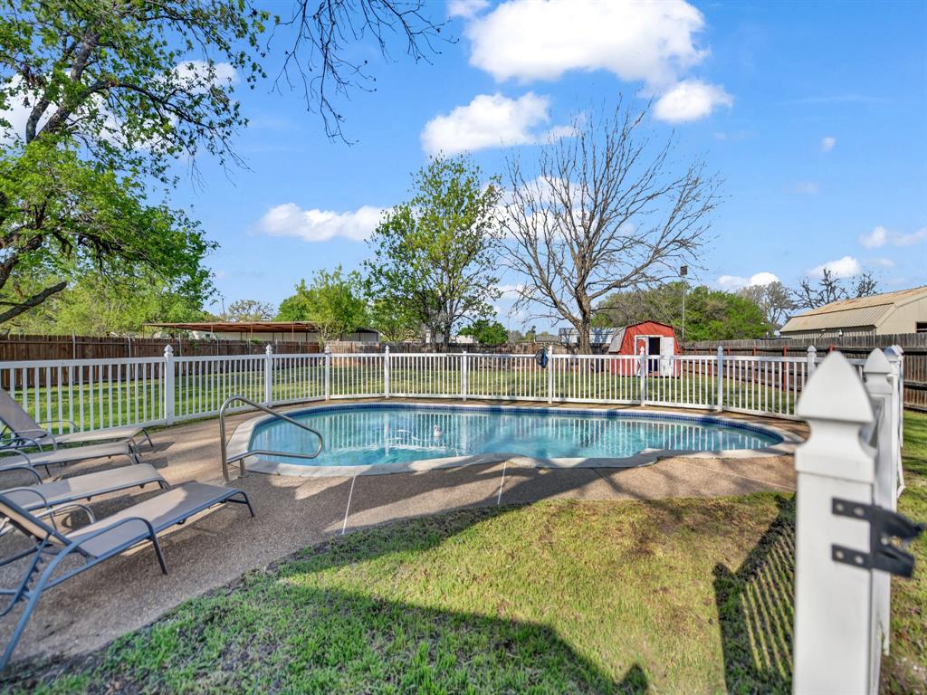 305 Gandy Street Lipan, TX 76462 - Photo 31 of 40 a view of a backyard with couches chair and wooden fence