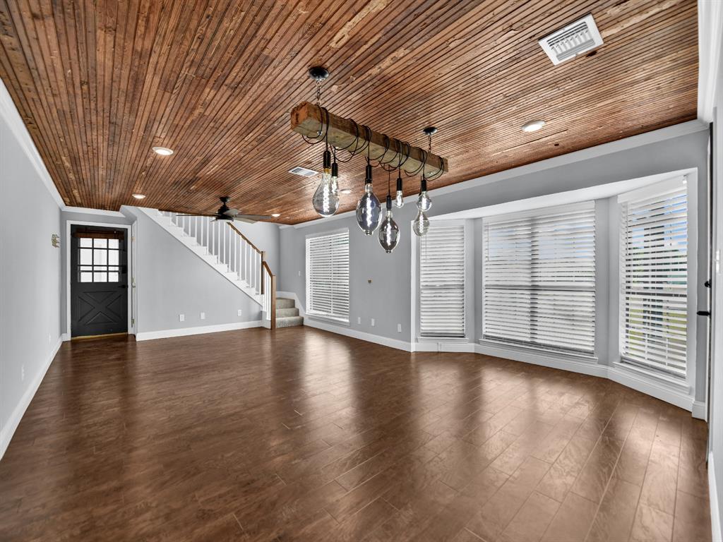 305 Gandy Street Lipan, TX 76462 - Photo 6 of 40 a view of a livingroom with wooden floors and stairs