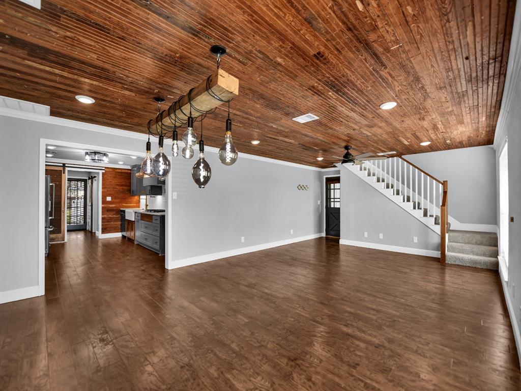 305 Gandy Street Lipan, TX 76462 - Photo 7 of 40 a view of a livingroom with wooden floor and stairs