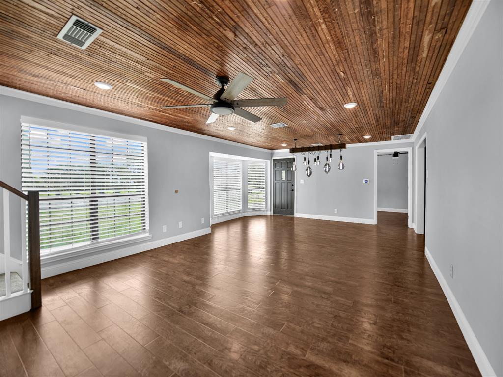 305 Gandy Street Lipan, TX 76462 - Photo 8 of 40 a view of empty room with wooden floor and fan