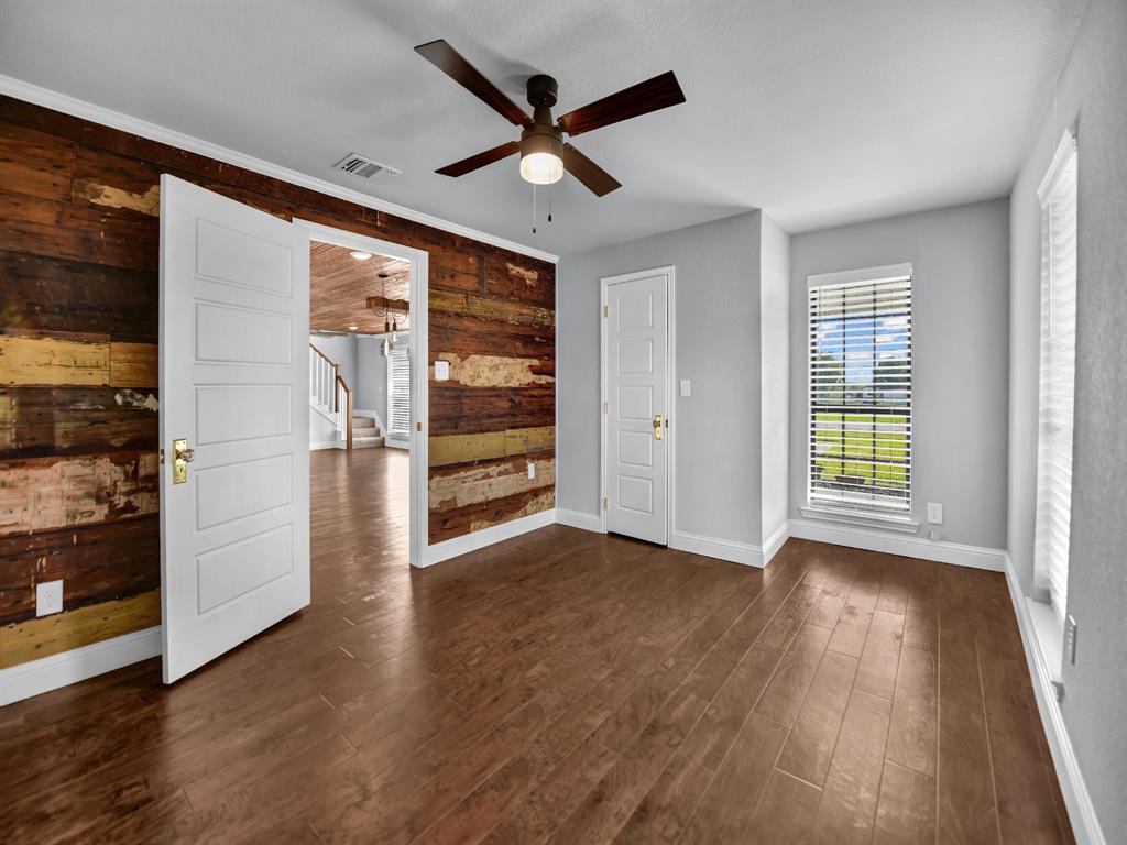 305 Gandy Street Lipan, TX 76462 - Photo 9 of 40 a view of empty room with wooden floor and fan