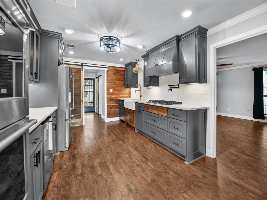 305 Gandy Street Lipan, TX 76462 - Photo 10 of 40 a large kitchen with a large counter top appliances and cabinets