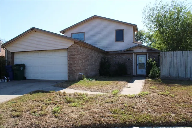 a front view of a house with a yard covered in snow