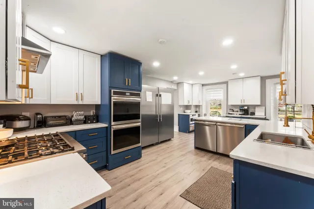 a kitchen with counter top space cabinets appliances and a window