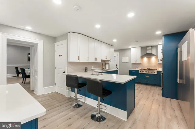 a kitchen with kitchen island granite countertop a sink stove and refrigerator