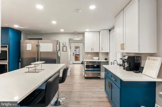 a kitchen with a sink stainless steel appliances and cabinets