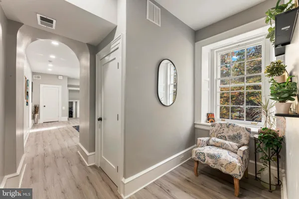 a spacious bedroom with a bed and a dresser