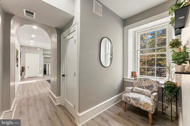 a spacious bedroom with a bed and a dresser