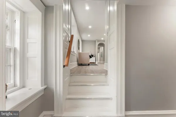 a bathroom with a toilet a sink and a mirror