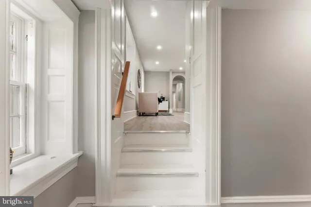 a bathroom with a toilet a sink and a mirror