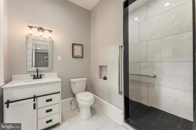 a bathroom with a glass shower door