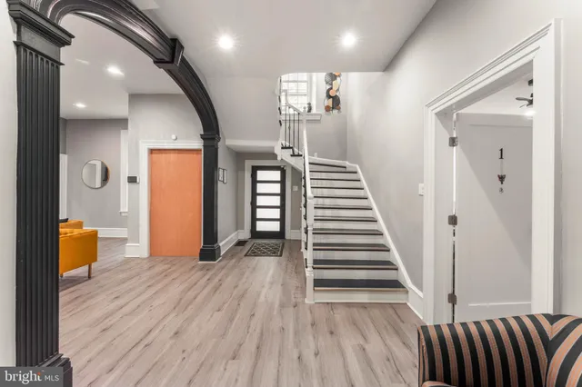 a living room with furniture and a chandelier