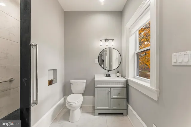 a bathroom with a double vanity sink toilet and shower