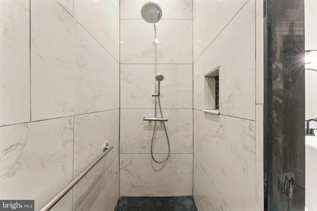 a view of a hallway with wooden floor and entryway