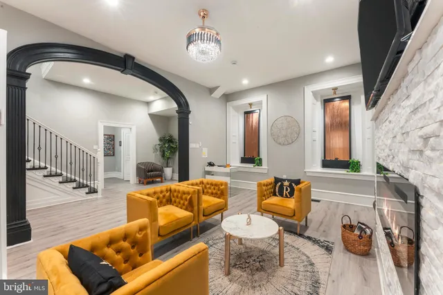 a living room with furniture a flat screen tv and a fireplace