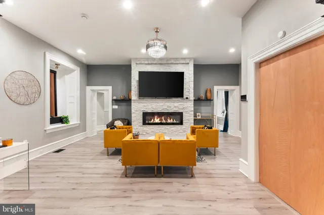 a view of a dining room with furniture a rug and wooden floor