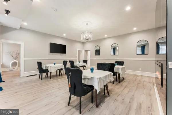 a large kitchen with a table and chairs