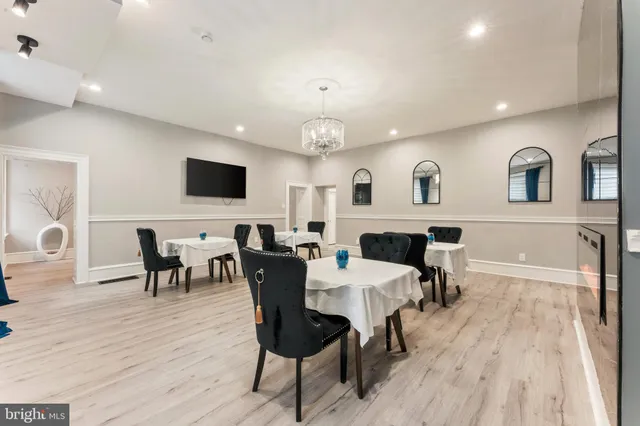 a large kitchen with a table and chairs