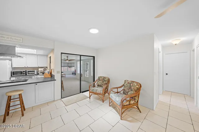 a kitchen with stainless steel appliances kitchen island granite countertop a refrigerator and a stove top oven