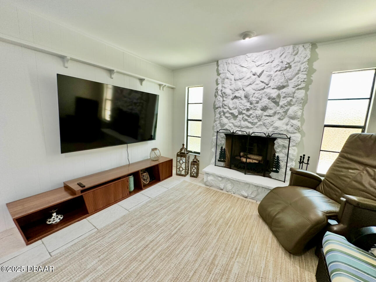 80 Cindy Lane Ponce Inlet, FL 32127 - Photo 17 of 45 a living room with a flat screen tv and a fireplace