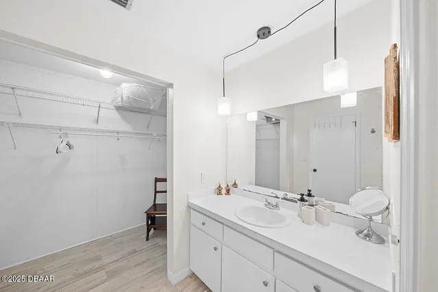 a bathroom with a double vanity sink mirror and shower