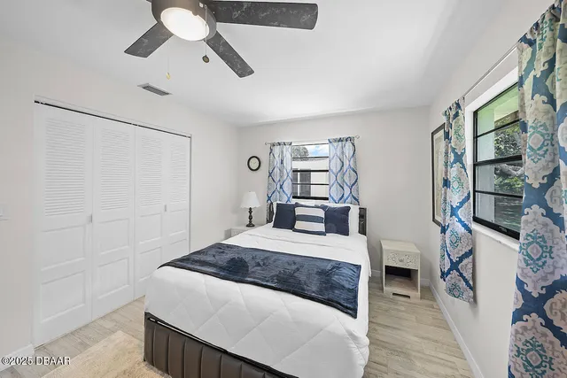 a bedroom with a large bed and a chandelier