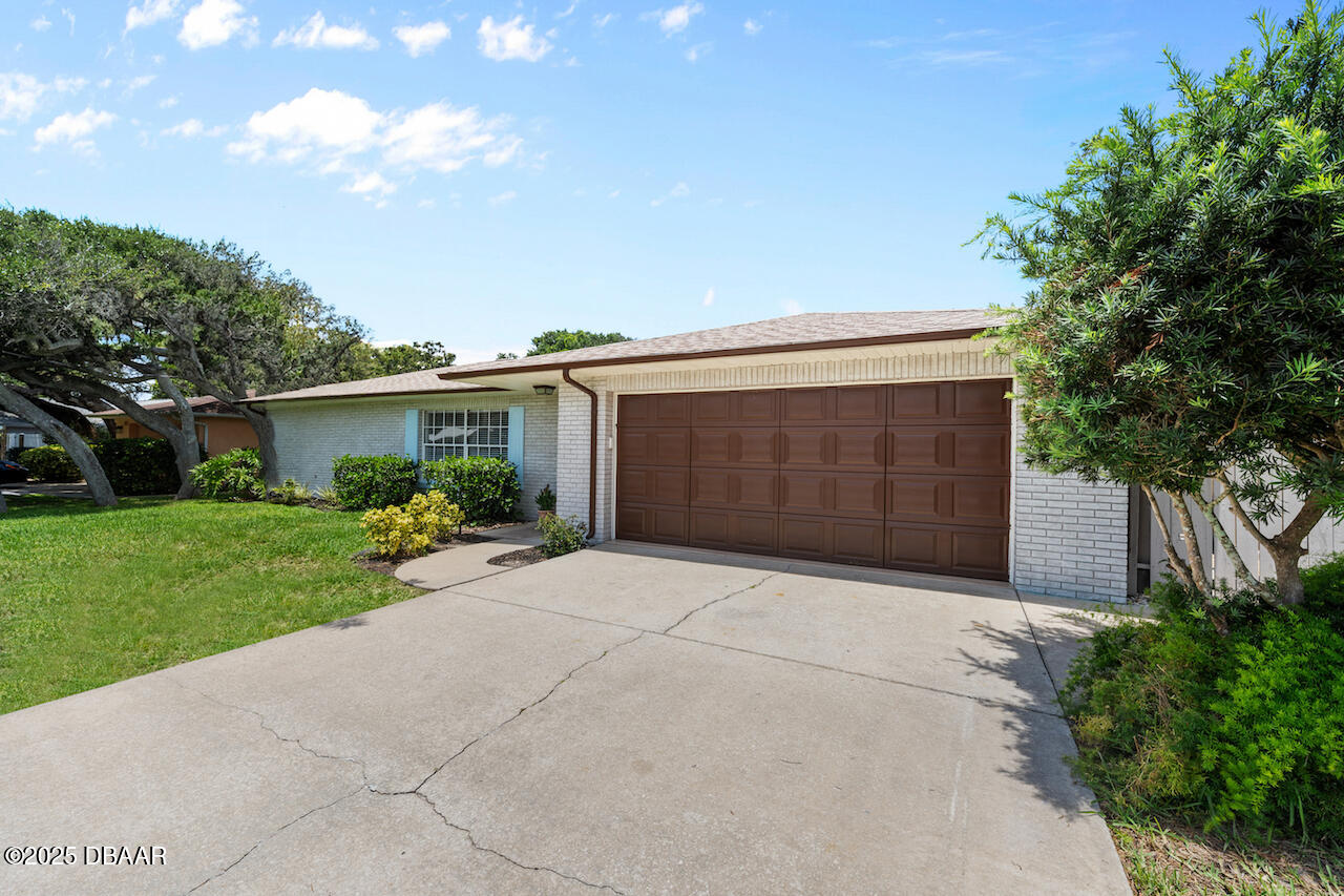 80 Cindy Lane Ponce Inlet, FL 32127 - Photo 3 of 45 a front view of house with yard and trees in the background