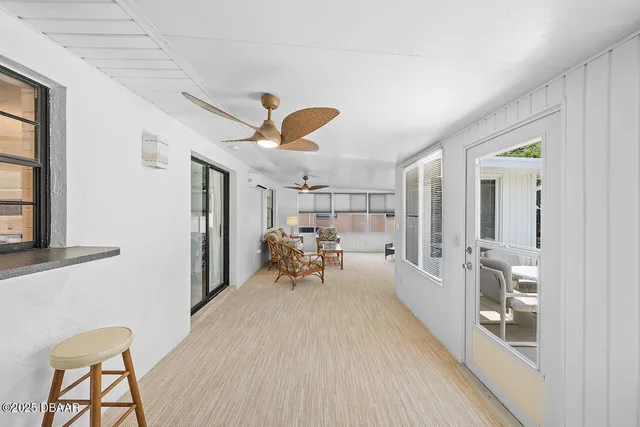 a view of a living room and a balcony
