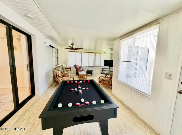 a room with furniture a window and a flat screen tv