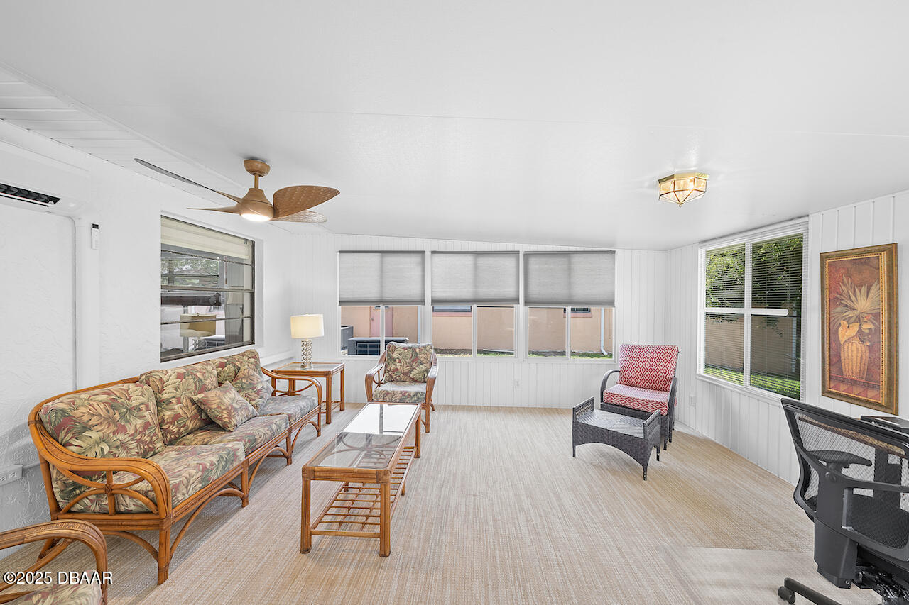 80 Cindy Lane Ponce Inlet, FL 32127 - Photo 39 of 45 a living room with furniture and a floor to ceiling window