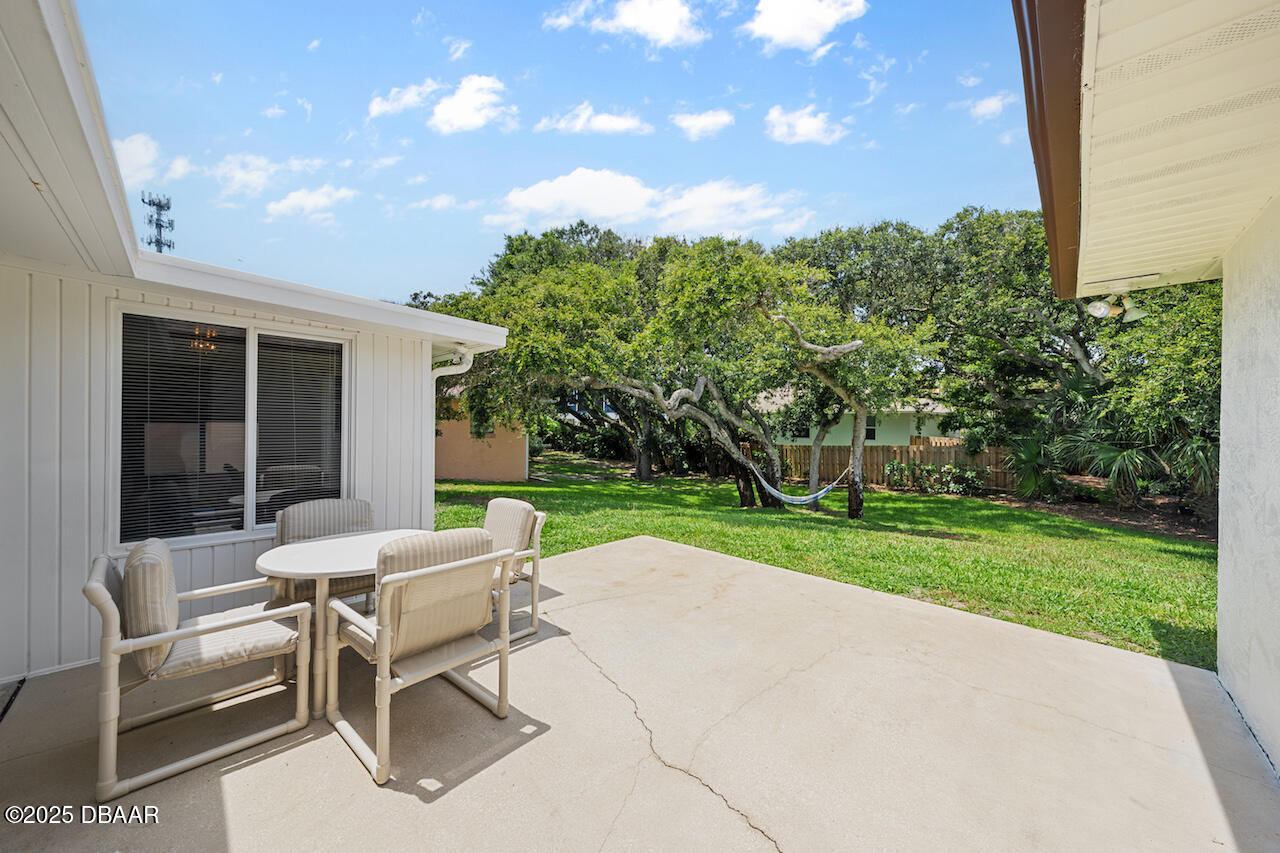 80 Cindy Lane Ponce Inlet, FL 32127 - Photo 41 of 45 a view of a patio with a garden