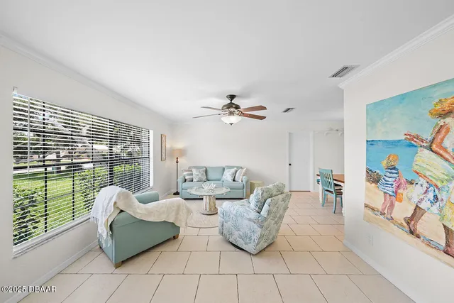 a living room with furniture and a floor to ceiling window