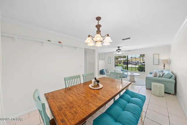 a living room with furniture and chandelier