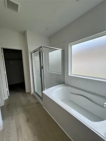 a white toilet sitting next to a wooden cabinet