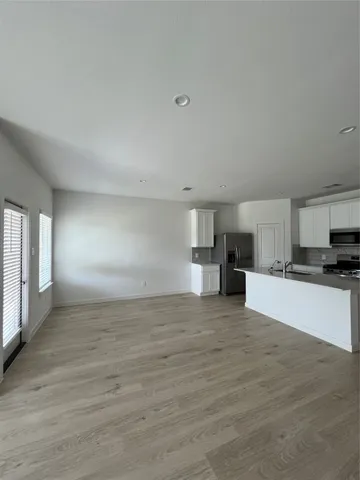 a view of a kitchen with a sink and a stove top oven