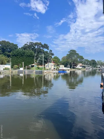a view of a lake with houses in the back