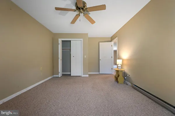 a view of empty room with ceiling fan