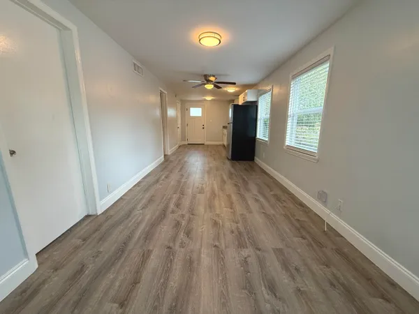 a view of a room with wooden floor and staircase